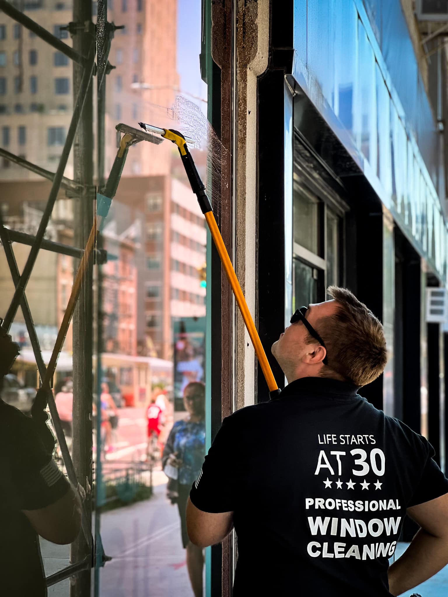Window cleaner cleaned storefront in Manhattan, NY